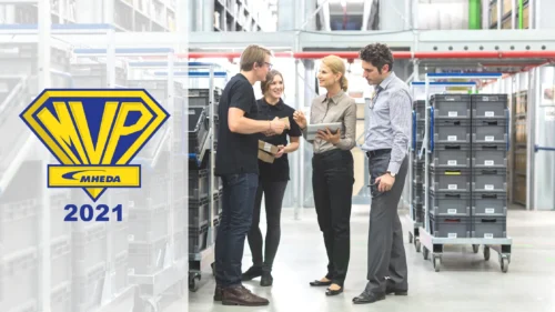 Woman holding tablet discussing business in warehouse